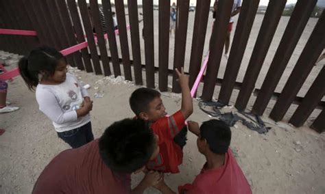 pink seesaws reach across the divide at us mexico border us mexico