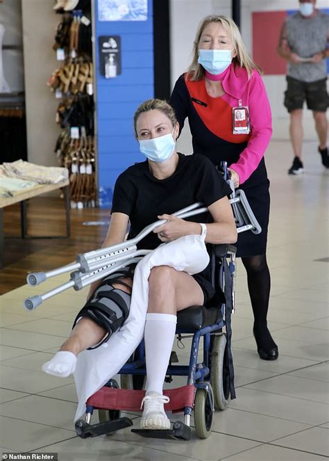 allison langdon is pushed through gold coast airport in a wheelchair