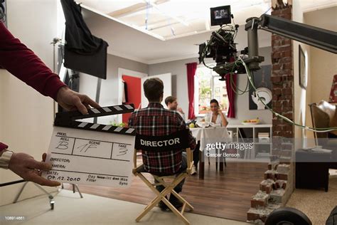 a director on a film set watching actors perform a scene