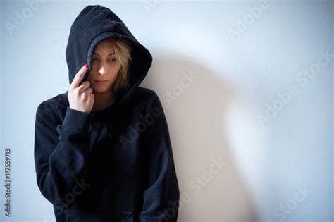 young girl hiding  face  hooded sweatshirt stockfotos und lizenzfreie bilder auf