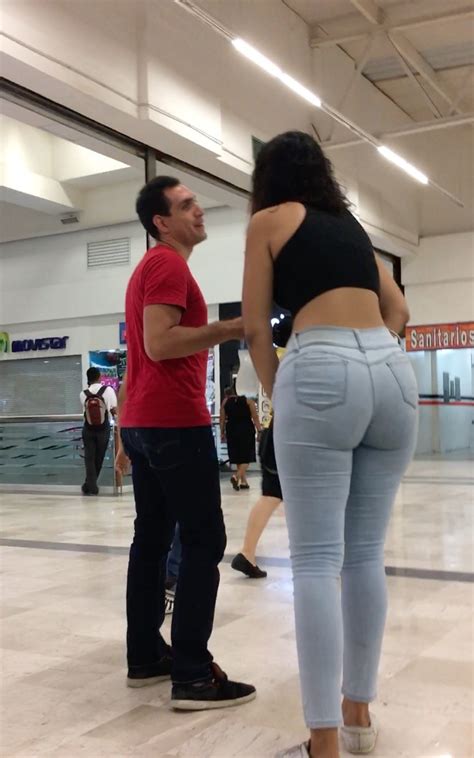 large brunette showing big ass with tight and light jeans