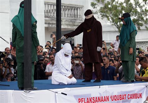 indonesia caning of couples for public affection and women for prostitution could be last before