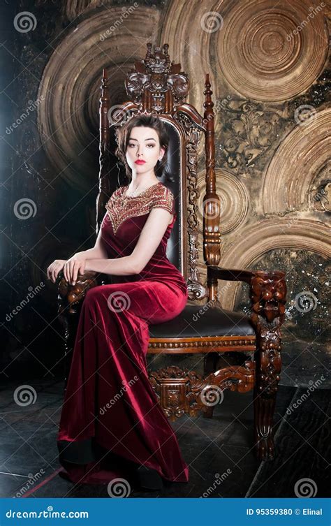 queen  red dress sitting  throne symbol  power stock photo