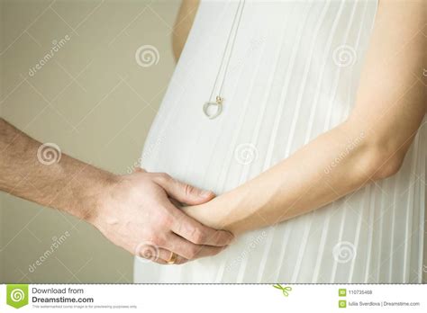 pregnant woman the father holds his wife`s hand future