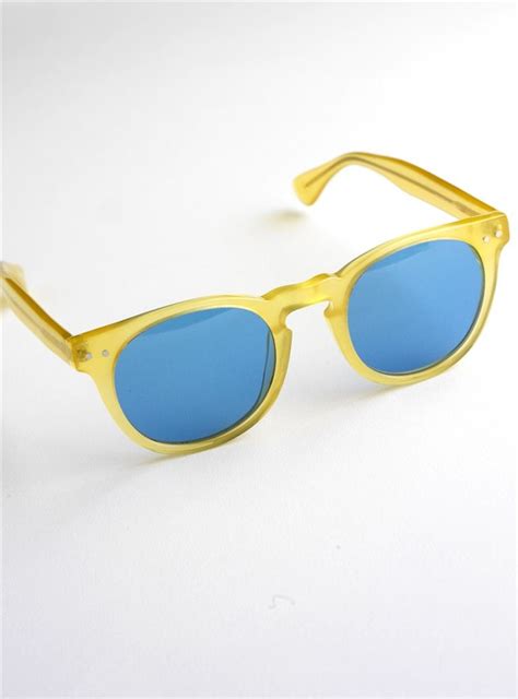 semi round sunglasses in yellow with blue lenses blue lenses round