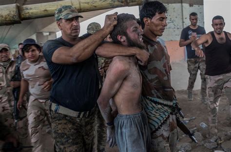 half naked isis fanatic is paraded for the cameras after being captured by iraqi forces