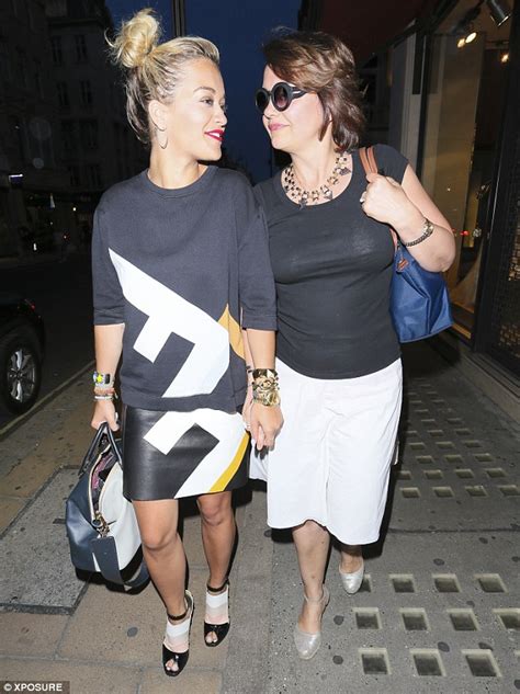 rita ora holds her mother s hand as they step out for an