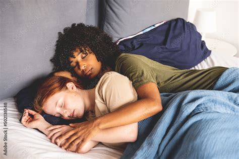 Young Lesbian Couple Lying And Sleeping In Their Bed Lgbt Lifestyle