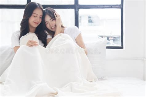 Two Beautiful Women Give Love While Sit On Bed Of Cozy Bedroom Lgbt