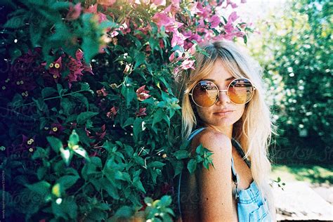 portrait of blonde girl with sunglasses outside by wendy laurel