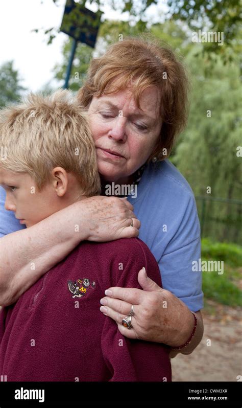 Grandma Hugging Polish Grandson Age 8 And 70 In City Park Spala