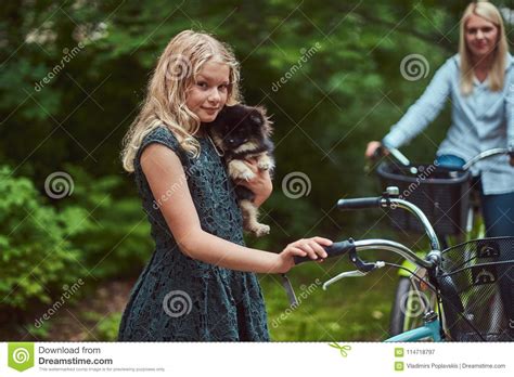 Portrait Of A Mother And Daughter With A Blonde Hair On A Bicycle Ride