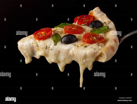 A Hot Pizza Slice With Dripping Melted Cheese Isolated On Black Stock