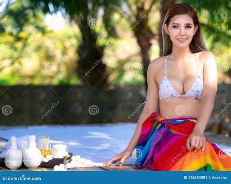 asian woman sit and relax in spa and wait for body massage stock image