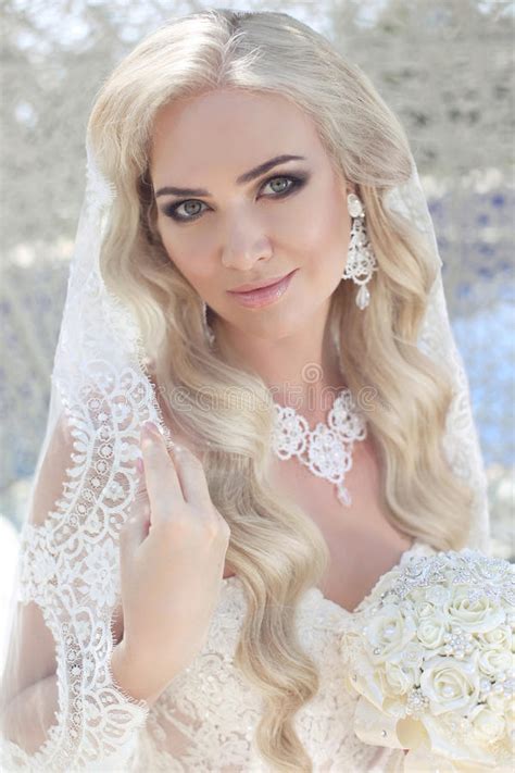 Beautiful Bride With Fashion Veil On Wedding Hairstyle Closeup Stock