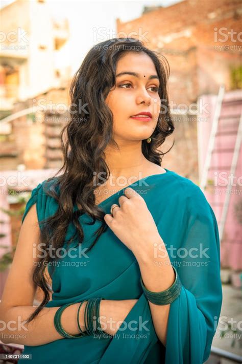 Portrait Of Beautiful Happy Indian Woman In Sari Looking Away And