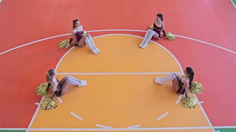 High Angle Slow Motion Video Of Four Synchronized Cheerleader Girls In