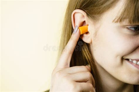 woman putting ear plugs  ears stock photo image  plug noise