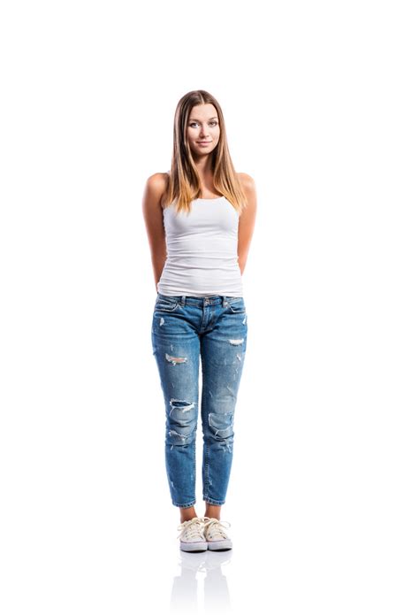 Standing Teenage Girl In Jeans Tight Singlet And Sneakers Hands