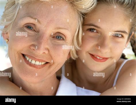 Young Girl Hugging Mature Woman From Behind Close Up Portrait Stock