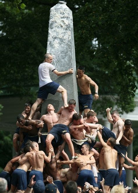 hot shirtless navy guys climbing a monument covered in lard naval