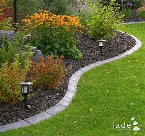 nicely defined flower bed  brick edging decor  front yard