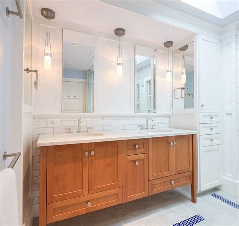 a custom cherry vanity cabinet provides visual contrast with the white