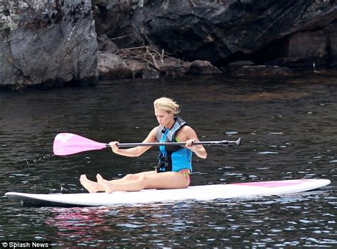 carrie underwood makes a splash in a colourful bikini before taking