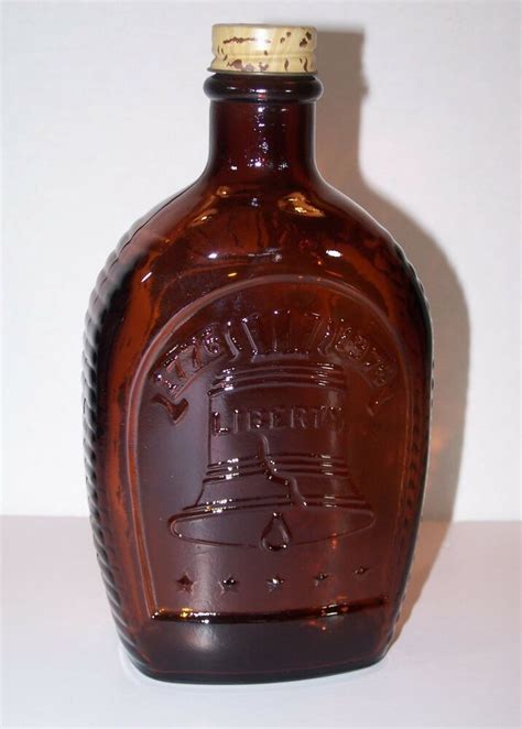 liberty bell flask log cabin syrup bicentennial amber glass bottle   logcabinsyrup
