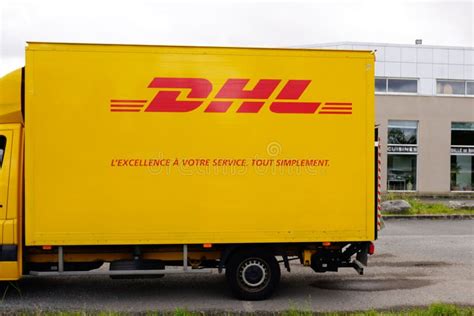 dhl logo  sign  delivery van car courier closeup yellow truck editorial stock photo image