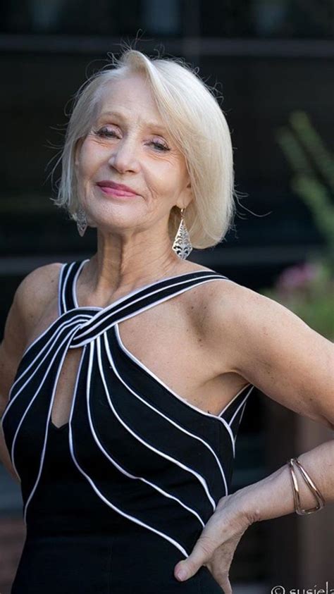 an older woman in a black and white dress with her hands on her hips
