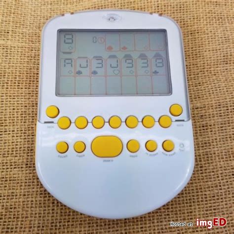 radica big screen solitaire 2008 electronic handheld game yellow lighted tested image on imged