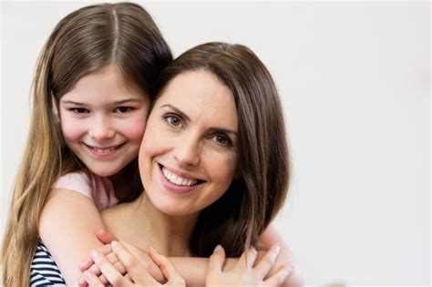 Free Photo Portrait Of Mother And Daughter Embracing