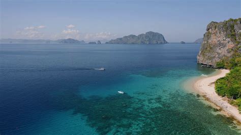 4k Aerial View Of First Tourists Boats Arriving The Tropical Beach Of