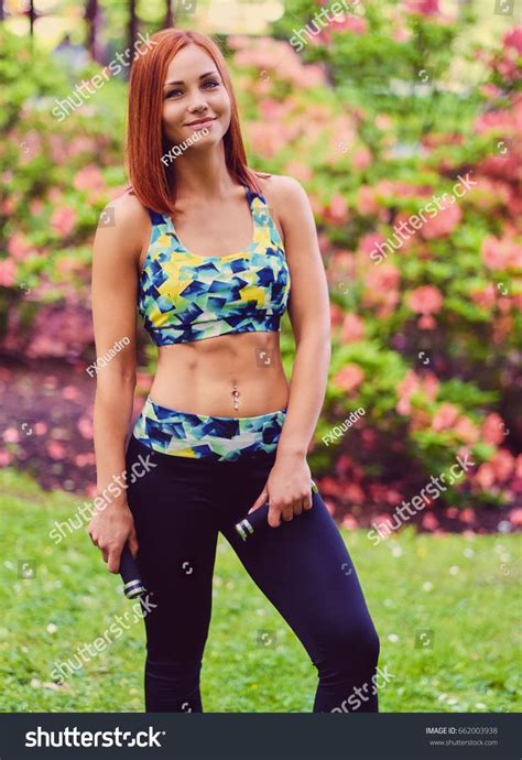 Redhead Female Doing Yoga In A Summer Park Ad