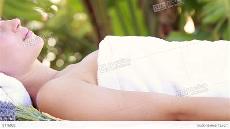 woman lying on massage table at tropical spa stock video footage 8116922