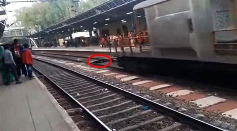 watch woman miraculously escapes death after coming under a running