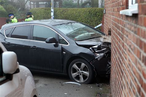 people rescued  car ploughs  wall  stockport home