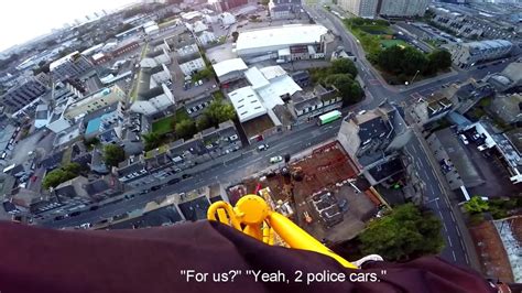 watch shocking moment maniac dangles from his fingertips 120ft up