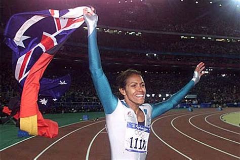 Cathy Freeman Carries Flags During A Victory Lap After At