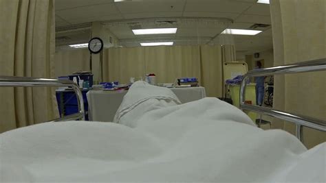 camera tracks   reveal boy lying  hospital bed listening