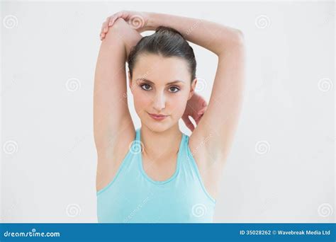 toned woman stretching hands  head  wall stock photography image