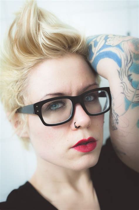 red lips short hair blonde nerd black glasses tattoos faux hawk