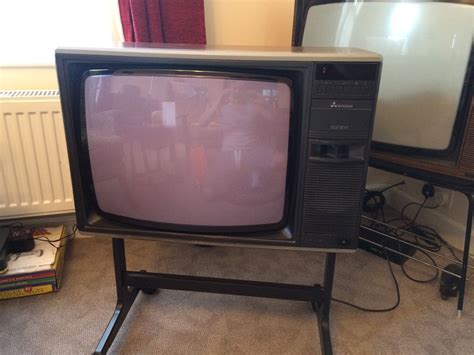television sitting  top   stand  front   tv set   screen turned