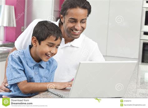 asian indian father and son using laptop computer stock image image 21929213