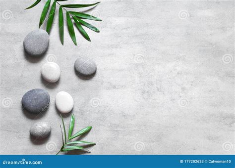 grey spa background spa concept palm leaves  grey stones top view