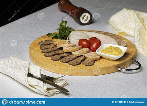 fork and knife in napkin assorted meat cheese sauce and