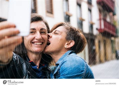 Happy Lesbian Couple Taking Selfie On Smartphone A Royalty Free Stock