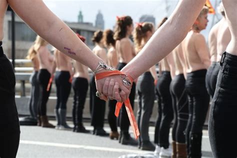 topless activists block bridge in london for international