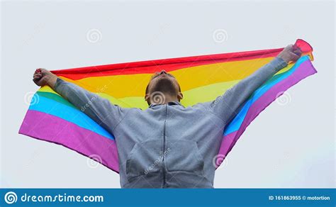 man raises rainbow flag march for lgbt right solidarity with same sex